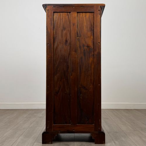 fig 4. A tall, narrow mahogany chest featuring seven drawers flanked by dark ebonised side columns on bracket feet.