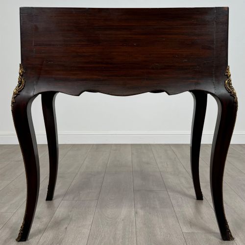 fig 5. A 19th-century French rosewood bureau de dame with floral marquetry inlay on the hinged top and apron, raised on cabriole legs with gilt-bronze ormolu mounts.