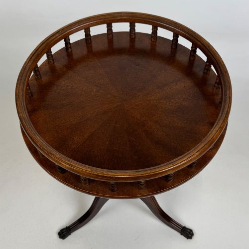 fig 4. A dark brown beech side table featuring a spindle gallery rim around the circular top, a turned column support, and a tripod base with claw feet.