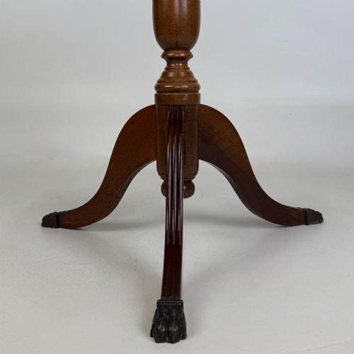 fig 7. A dark brown beech side table featuring a spindle gallery rim around the circular top, a turned column support, and a tripod base with claw feet.