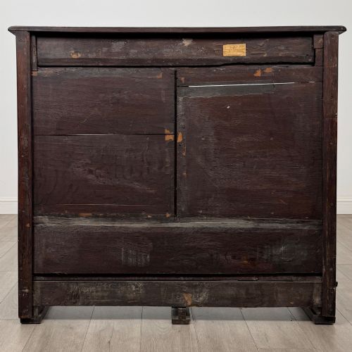 fig 4. A 19th-century dark oak open bookcase featuring hand-carved frieze foliage, a central mask motif, and three tiers of open shelving.