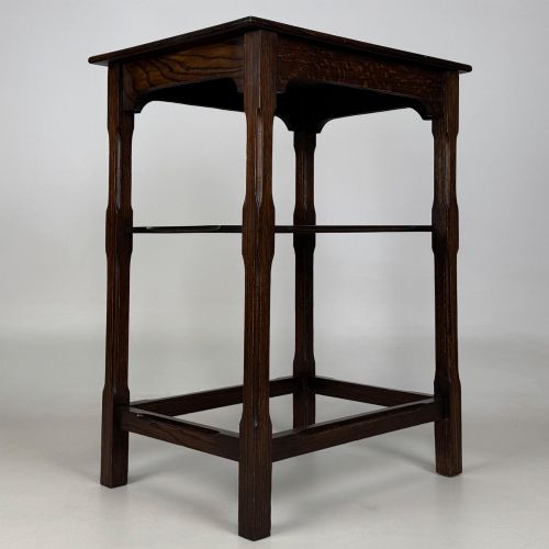 fig 3. An Edwardian dark oak side table with a flat square top, lower tier shelf, shaped aprons, and straight square legs.