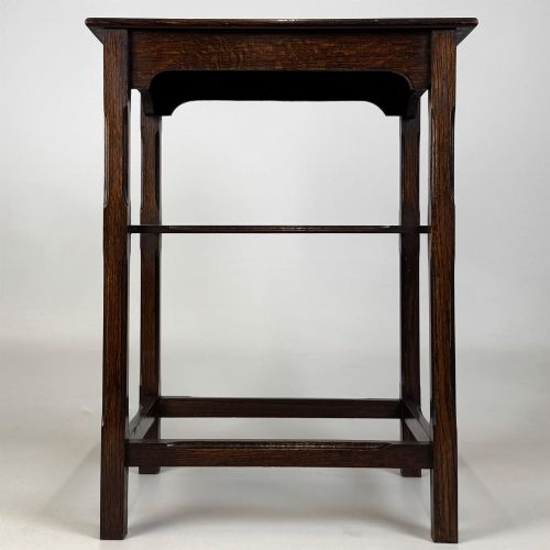 fig 4. An Edwardian dark oak side table with a flat square top, lower tier shelf, shaped aprons, and straight square legs.