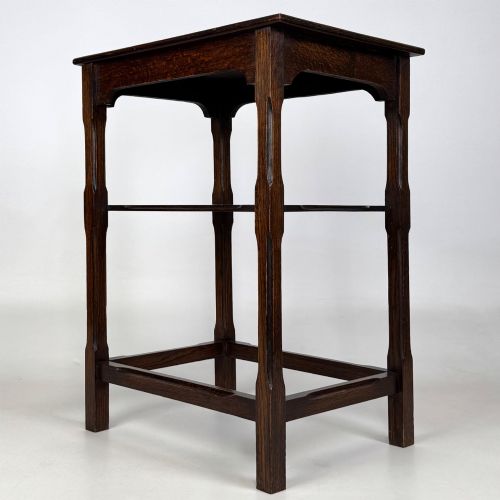 fig 5. An Edwardian dark oak side table with a flat square top, lower tier shelf, shaped aprons, and straight square legs.