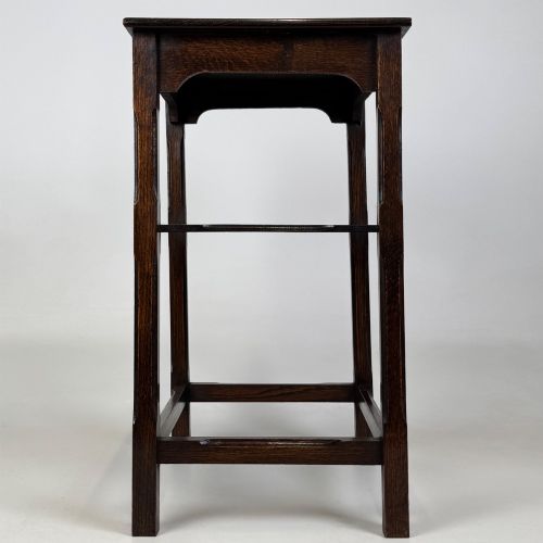 fig 6. An Edwardian dark oak side table with a flat square top, lower tier shelf, shaped aprons, and straight square legs.