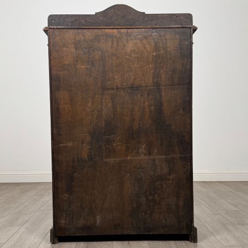 fig 5. An Edwardian dark-stained oak open bookcase featuring four shelf tiers containing red leather-bound books against a white background.