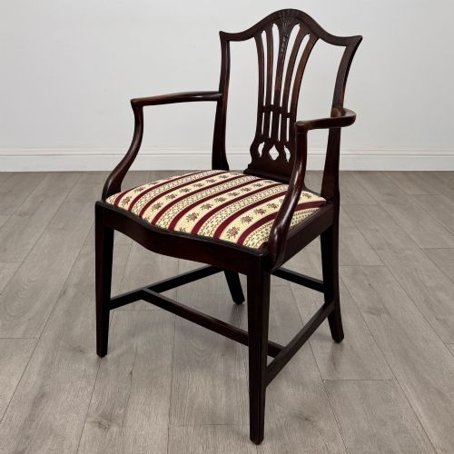 fig 1. A set of eight dark mahogany shield back dining chairs, including two carvers and six side chairs, with striped red and cream upholstery.