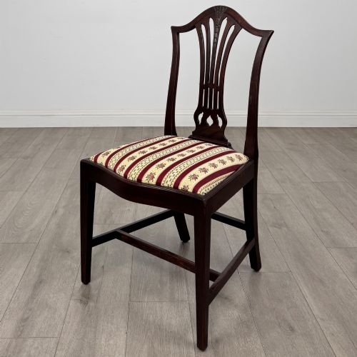 fig 2. A set of eight dark mahogany shield back dining chairs, including two carvers and six side chairs, with striped red and cream upholstery.