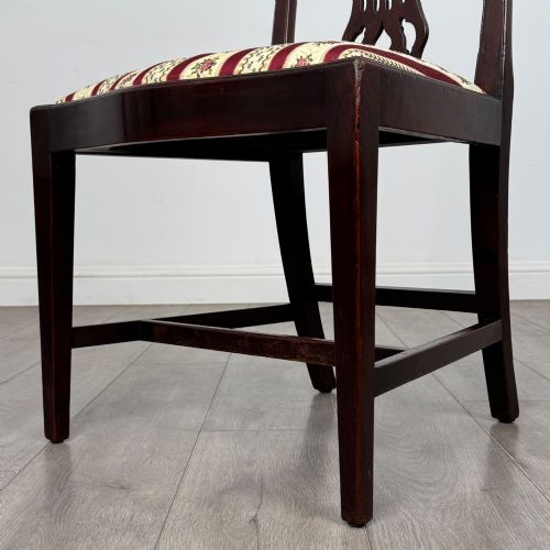 fig 5. A set of eight dark mahogany shield back dining chairs, including two carvers and six side chairs, with striped red and cream upholstery.