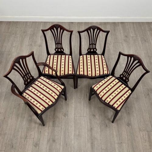 fig 7. A set of eight dark mahogany shield back dining chairs, including two carvers and six side chairs, with striped red and cream upholstery.