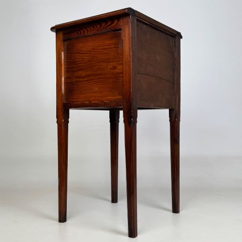 fig 3. A Victorian pitch pine cabinet with three drawers and black wooden knobs set on elevated tapered square legs.