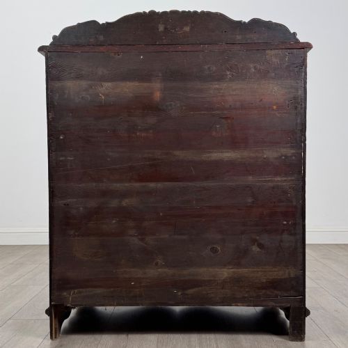 fig 5. A dark oak Victorian slant-front bureau featuring carved Green Man drawer pulls, foliage relief carvings, and a single panelled cupboard door.