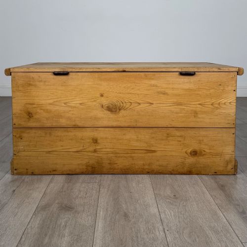fig 4. A 19th-century Victorian pine blanket box featuring a flat hinged lid, visible wood grain, central keyhole, and solid plinth base.