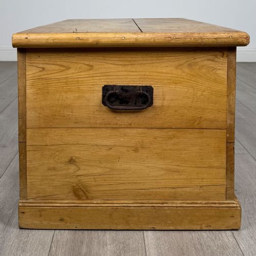 fig 6. A 19th-century Victorian pine blanket box featuring a flat hinged lid, visible wood grain, central keyhole, and solid plinth base.
