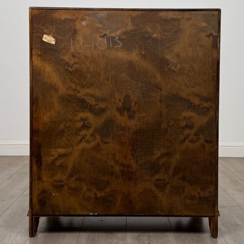 fig 5. A dark oak slant-front writing bureau featuring carved linenfold upper panels, a single carved drawer with wooden knobs, and a double-door cupboard base decorated with diamond lozenge carvings.