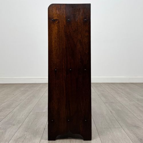 fig 3. An early 20th-century dark oak display cabinet featuring twin glazed doors, an interior shelf, and a gallery top.