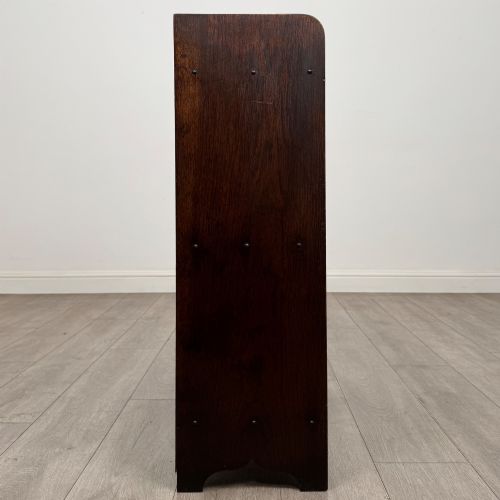fig 7. An early 20th-century dark oak display cabinet featuring twin glazed doors, an interior shelf, and a gallery top.