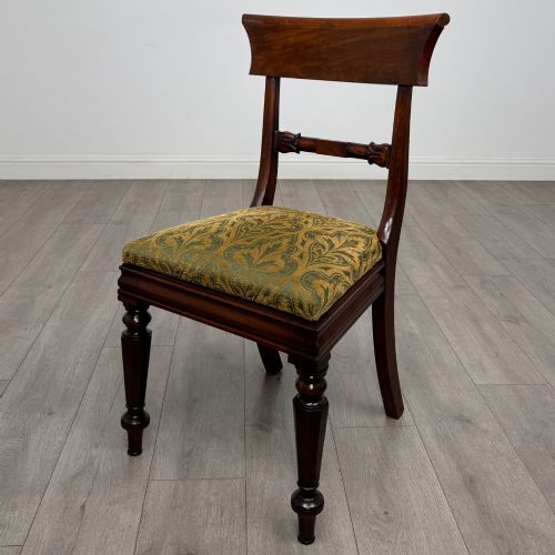 fig 1. A set of six 19th-century William IV mahogany dining chairs featuring turned front legs, curved back rails, and green patterned fabric seats.