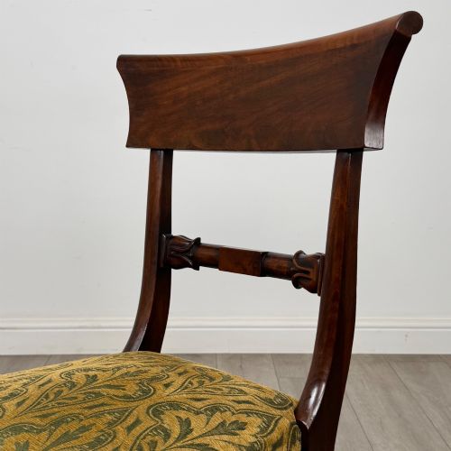 fig 3. A set of six 19th-century William IV mahogany dining chairs featuring turned front legs, curved back rails, and green patterned fabric seats.
