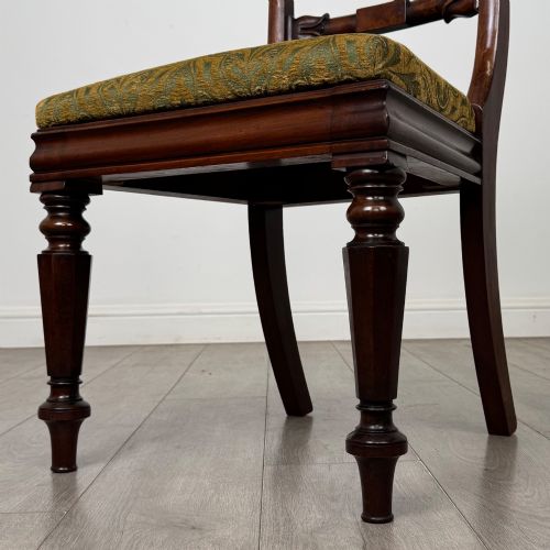 fig 4. A set of six 19th-century William IV mahogany dining chairs featuring turned front legs, curved back rails, and green patterned fabric seats.