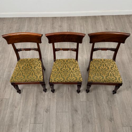 fig 6. A set of six 19th-century William IV mahogany dining chairs featuring turned front legs, curved back rails, and green patterned fabric seats.
