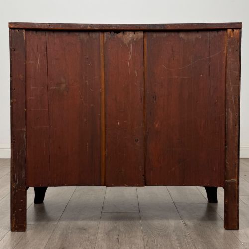 fig 4. An 18th-century Georgian mahogany bow-front chest of drawers featuring two short over two long drawers with brass oval handles and splayed bracket feet.