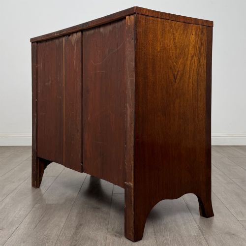 fig 5. An 18th-century Georgian mahogany bow-front chest of drawers featuring two short over two long drawers with brass oval handles and splayed bracket feet.