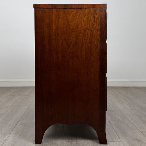 fig 6. An 18th-century Georgian mahogany bow-front chest of drawers featuring two short over two long drawers with brass oval handles and splayed bracket feet.