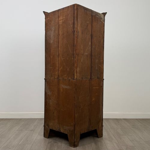 fig 2. An eighteenth century Georgian dark oak standing corner cabinet featuring upper geometric astragal glazed doors and lower panelled cupboard doors.