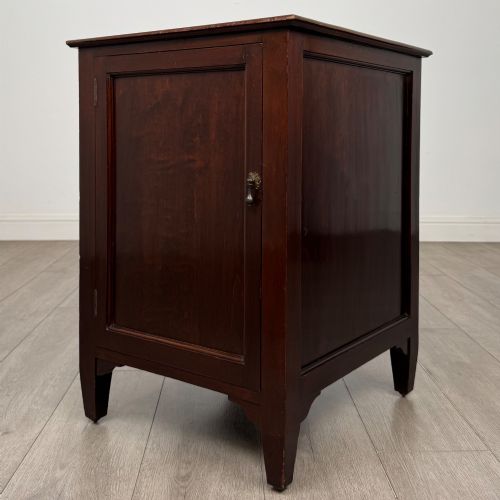 fig 2. A dark stained oak Edwardian cupboard featuring a single panel door, teardrop handle, and square tapered legs.