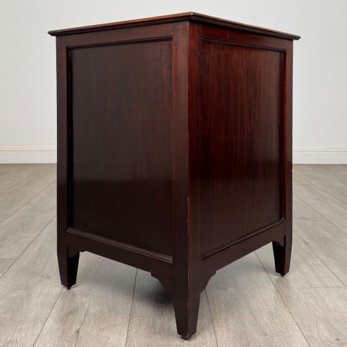 fig 6. A dark stained oak Edwardian cupboard featuring a single panel door, teardrop handle, and square tapered legs.