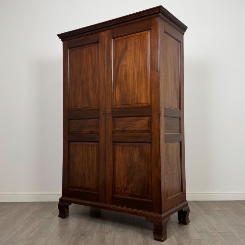fig 2. An 18th-century Georgian mahogany two-door wardrobe featuring fielded panel doors, a dentil-moulded cornice, and shaped bracket feet.