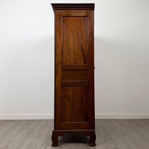 fig 3. An 18th-century Georgian mahogany two-door wardrobe featuring fielded panel doors, a dentil-moulded cornice, and shaped bracket feet.