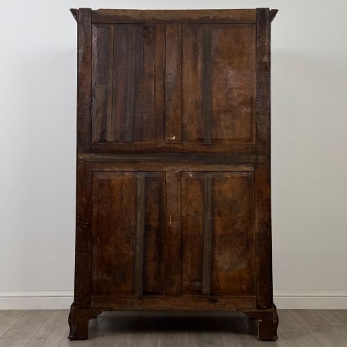 fig 5. An 18th-century Georgian mahogany two-door wardrobe featuring fielded panel doors, a dentil-moulded cornice, and shaped bracket feet.