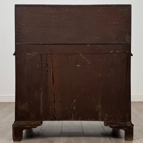 fig 5. An 18th-century dark oak Georgian bureau with a slant-front writing slope, brass batwing drop handles, and bracket feet.