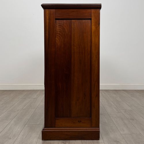 fig 2. An Edwardian walnut chest of drawers featuring a two over three drawer layout with brass drop handles and a solid plinth base.