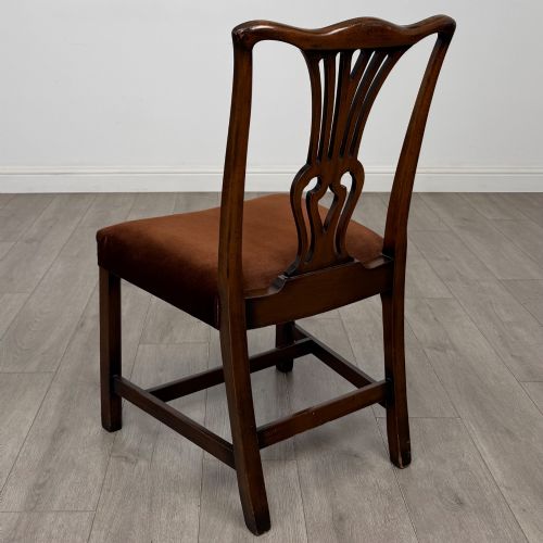 fig 2. A set of six dark wood Georgian style dining chairs featuring pierced splat backs and dark brown velvet upholstered seats.