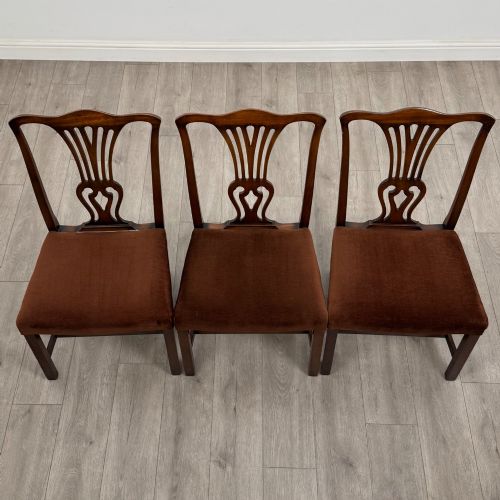 fig 6. A set of six dark wood Georgian style dining chairs featuring pierced splat backs and dark brown velvet upholstered seats.
