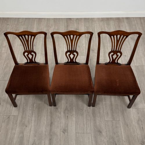fig 7. A set of six dark wood Georgian style dining chairs featuring pierced splat backs and dark brown velvet upholstered seats.