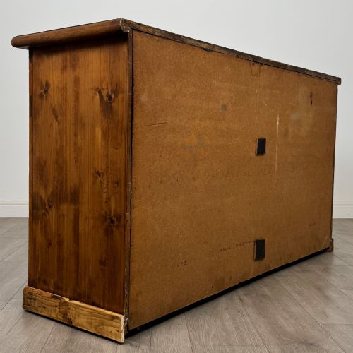 fig 4. A 19th-century pine farmhouse dresser base featuring three upper drawers above two cupboard doors and an open central shelf.