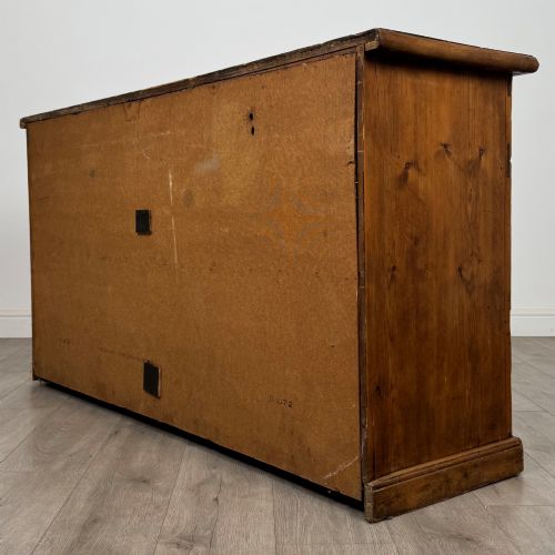 fig 6. A 19th-century pine farmhouse dresser base featuring three upper drawers above two cupboard doors and an open central shelf.