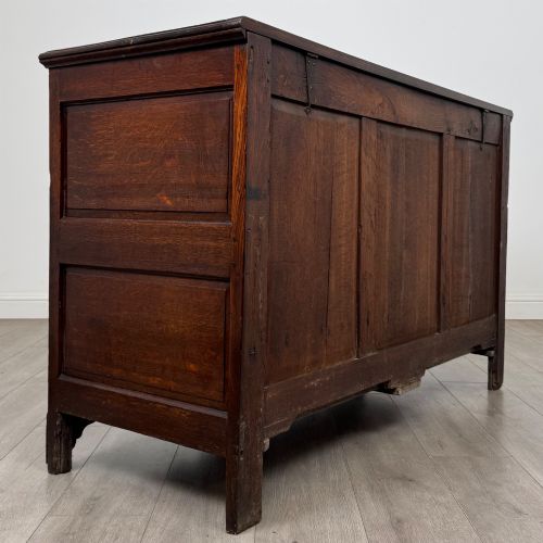 fig 3. An 18th-century Georgian oak mule chest featuring four arched fielded panels, two base drawers with brass hardware, and a shaped apron.