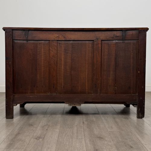 fig 4. An 18th-century Georgian oak mule chest featuring four arched fielded panels, two base drawers with brass hardware, and a shaped apron.
