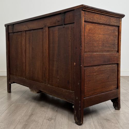 fig 5. An 18th-century Georgian oak mule chest featuring four arched fielded panels, two base drawers with brass hardware, and a shaped apron.