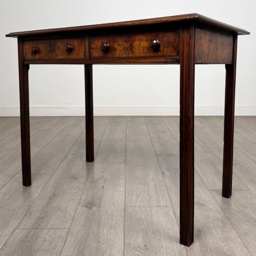 fig 1. A dark mahogany Georgian style writing table featuring two frieze drawers with turned wood knobs and straight legs.