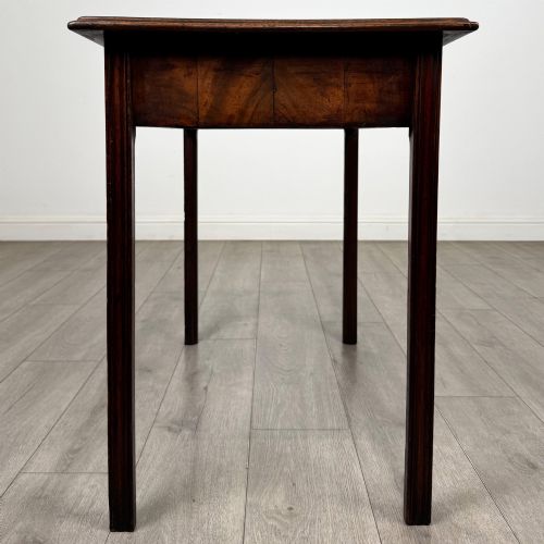fig 2. A dark mahogany Georgian style writing table featuring two frieze drawers with turned wood knobs and straight legs.
