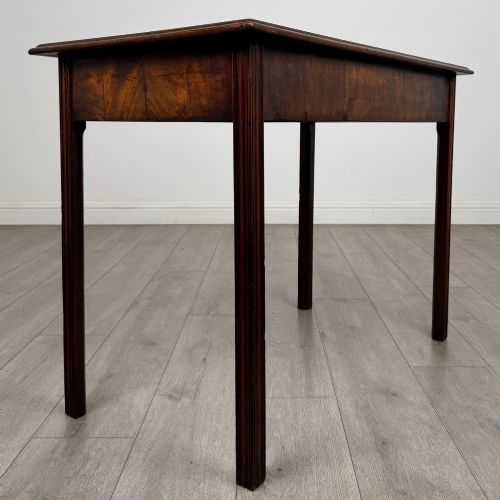 fig 3. A dark mahogany Georgian style writing table featuring two frieze drawers with turned wood knobs and straight legs.