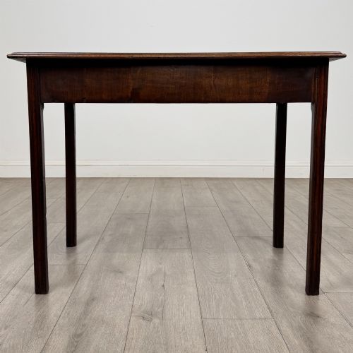 fig 4. A dark mahogany Georgian style writing table featuring two frieze drawers with turned wood knobs and straight legs.