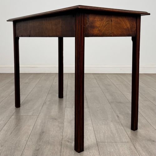 fig 5. A dark mahogany Georgian style writing table featuring two frieze drawers with turned wood knobs and straight legs.