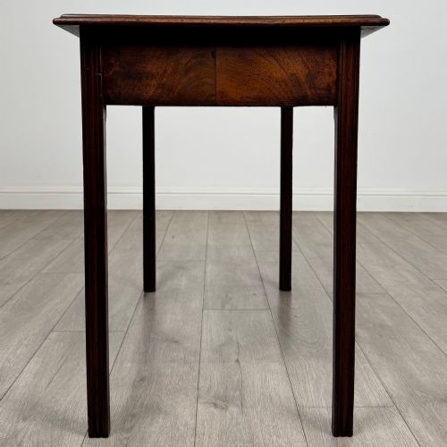 fig 6. A dark mahogany Georgian style writing table featuring two frieze drawers with turned wood knobs and straight legs.
